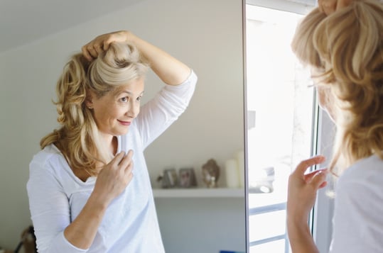 woman looking in mirror