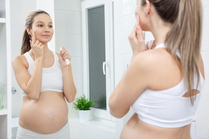 Pregnant woman in mirror